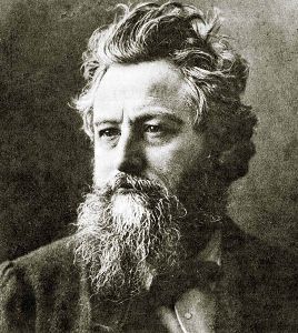 Featured is an historical photo of William Morris, one of the premier contributors to the English Arts & Crafts aesthetic and movement.  Morris, an architect and furniture, and textile designer was best known for his repeating patterns on wallpapers and textiles that were taken from nature.  His contributions appeared in the early days of the arts and crafts movement; he died at its outset in the mid 1890s.